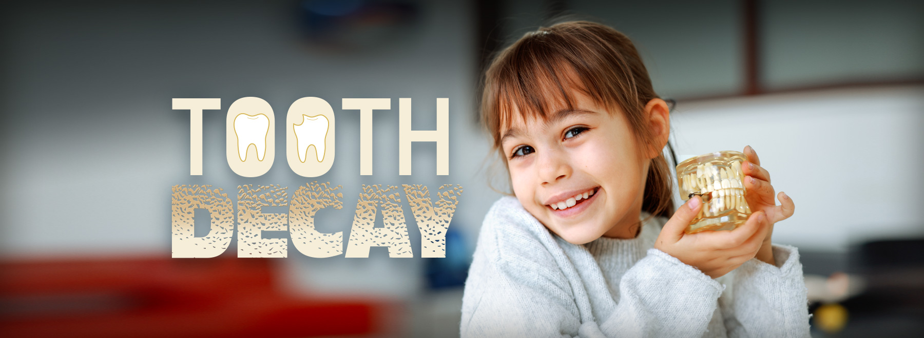 young girl holds a decayed tooth, highlighting the issue of tooth decay in children.